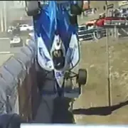 Car flipping over guardrail