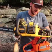 Taras Kul holding two chainsaws