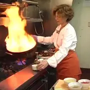 Woman holding pan on fire