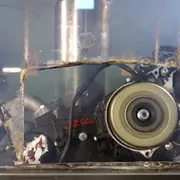 Running engine being crushed