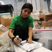 Postal worker marking package