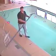 Man about to fall into swimming pool