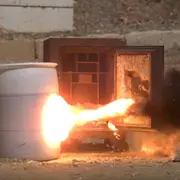 A safe door being pierced by explosives 