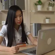 Woman making online purchase with credit card