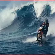 Motorcycle riding a wave